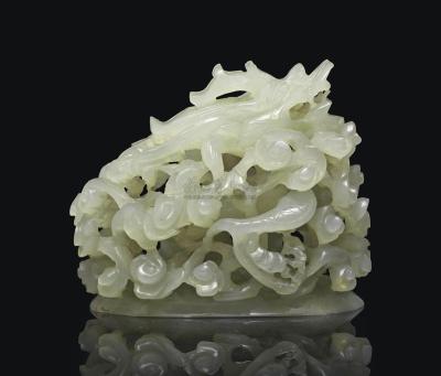 A CARVED AND RETICULATED WHITE JADE‘ DRAGON’ FINIAL