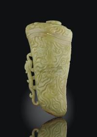 A CARVED YELLOWISH-GREEN JADE RHYTON AND COVER